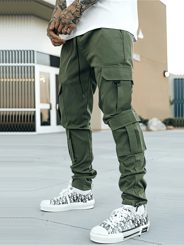 Model wearing green joggers with multiple pockets, showcasing style and functionality.